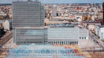 A modern building with a glass facade and a covered pedestrian area.
