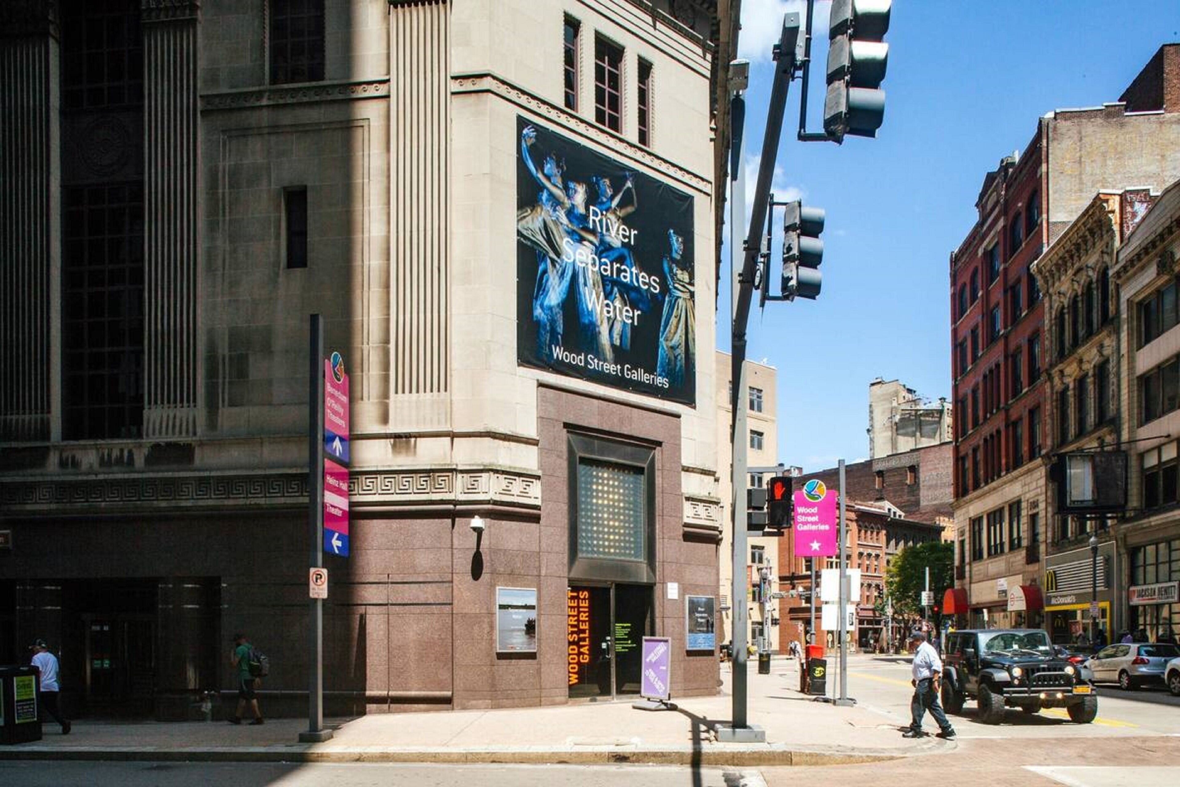 A building with a large advertisement for Wood Street Galleries.