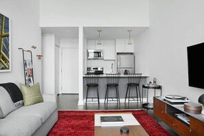 42-inch flat-screen TV with digital channels, TV, streaming services - Abode Pittsburgh - Downtown Convention Center (Pittsburgh)