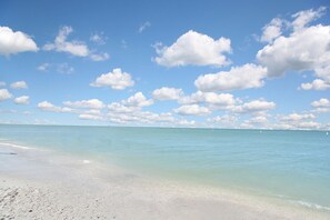 A beach with clear turquoise water and white sand.