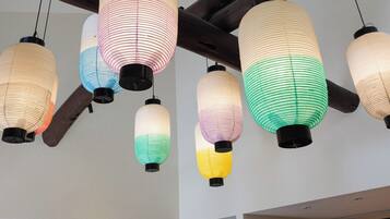A ceiling with multiple hanging lanterns and a wooden beam structure.