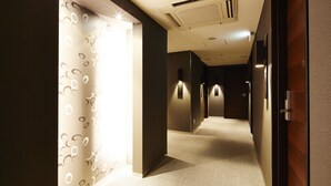 A hotel hallway with patterned walls, a carpeted floor, and recessed lighting. - KOKO HOTEL Fukuoka Tenjin (Fukuoka)