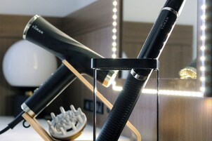 A hairdryer and a vacuum cleaner on display.