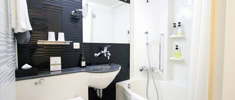 A modern bathroom with a black and white tiled wall, a white sink, a mirror, a bathtub, and a shower.