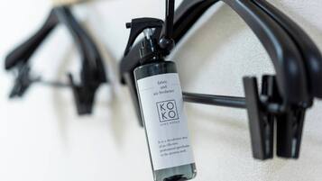 A deodorant spray bottle labeled 'KO KO Hotels' mounted on a wall.