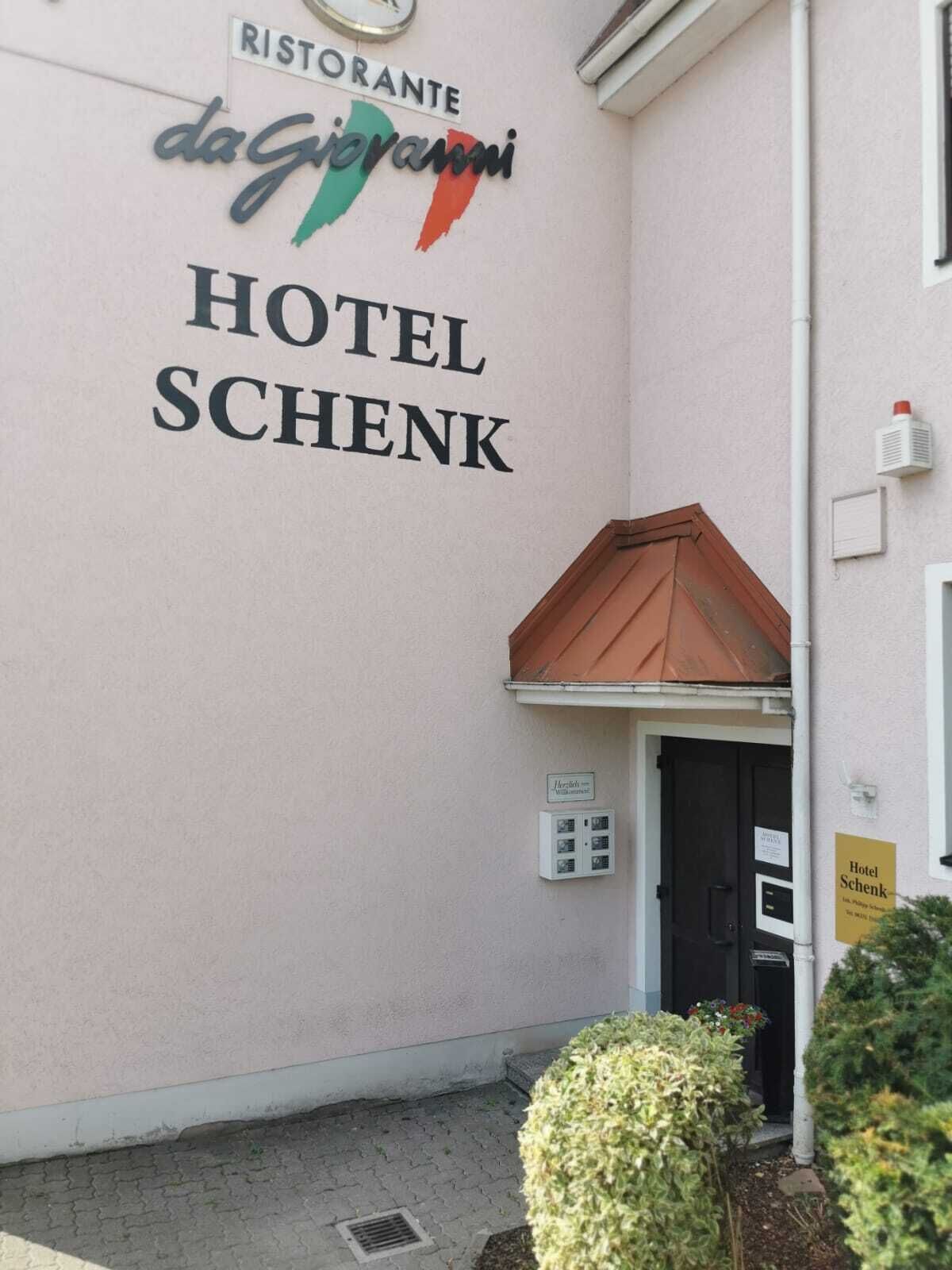 A building with a sign for "Hotel Schenk" and a restaurant named "da Giovanni Ristorante."