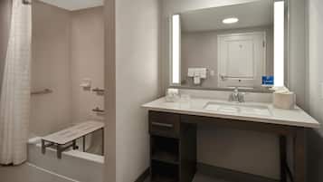 A modern bathroom with a shower, a sink with a mirror, and a towel rack.