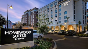 A hotel entrance with a sign reading "HOMEWOOD SUITES by Hilton."