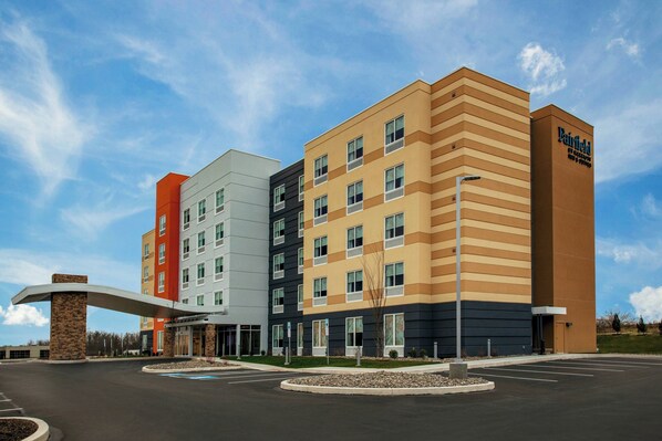 Hotel entrance with covered walkway and well-maintained parking.