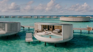 Overwater bungalows with a pool, wooden deck, and a view of the ocean. - The Ritz-Carlton Maldives, Fari Islands (Fari Islands)