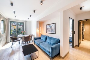 Deluxe Apartment, Balcony, Mountain View | Living area | 55-inch LED TV with cable channels, TV, Netflix