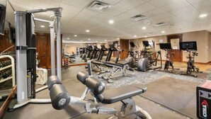 A gym with various exercise equipment, including treadmills, stationary bikes, and weight machines. - Value Condo, Hot Tub and Pool, Walk to Trails! (Durango)