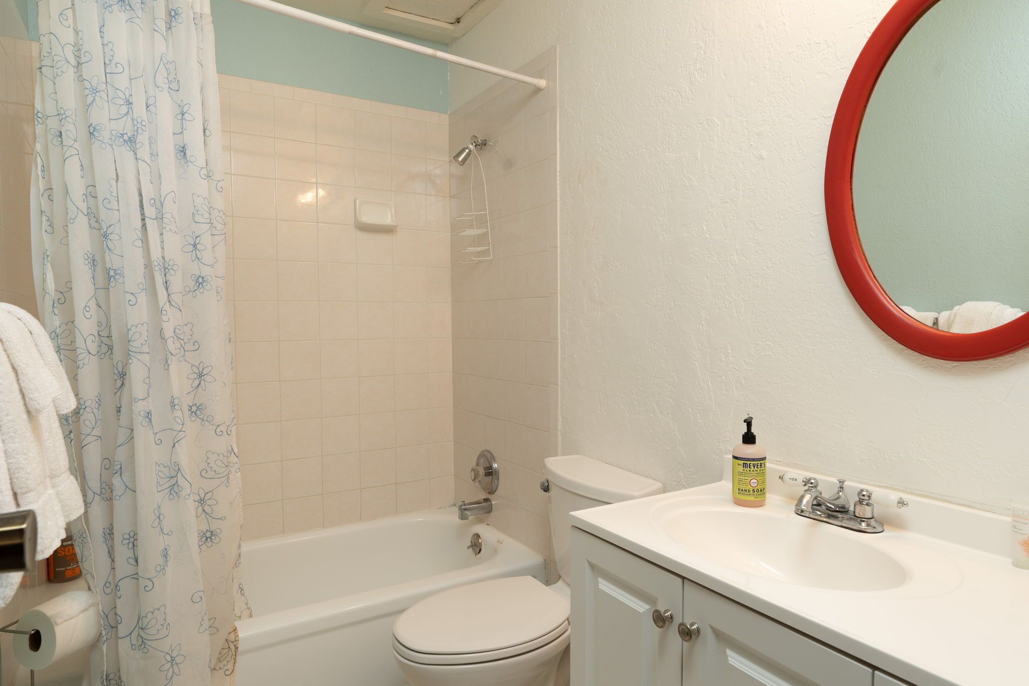 A bathroom with a bathtub, toilet, and sink.