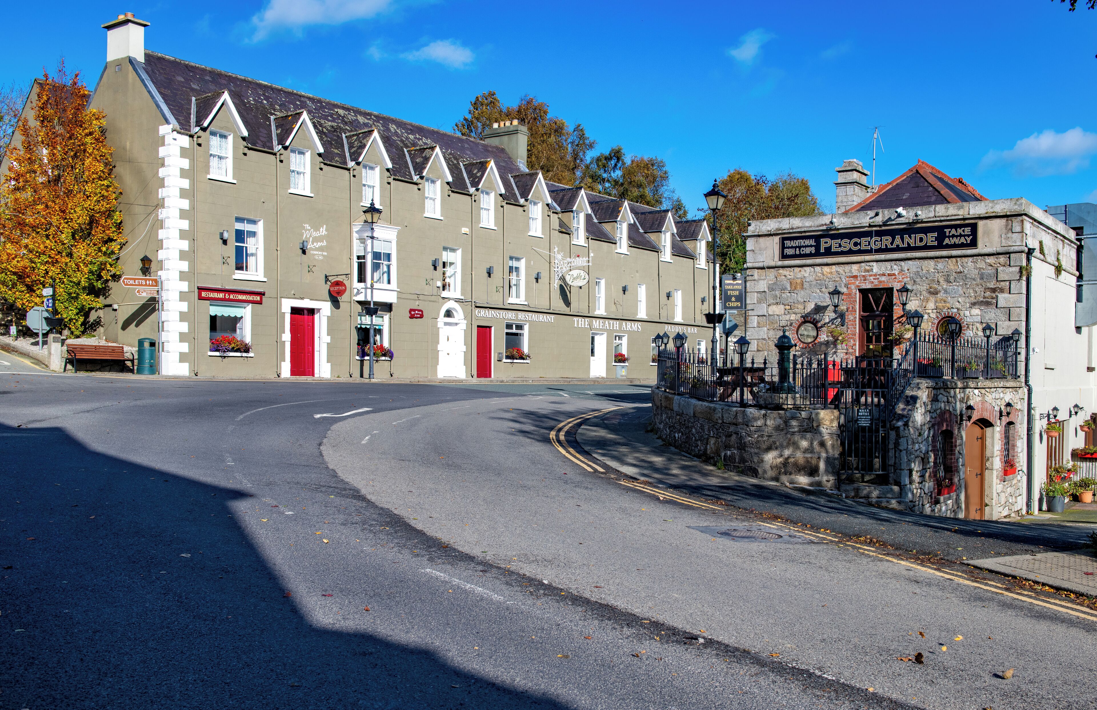 A street view with a traditional building labeled "The Meath Arms" and a sign for "Pescogrande Take Away."