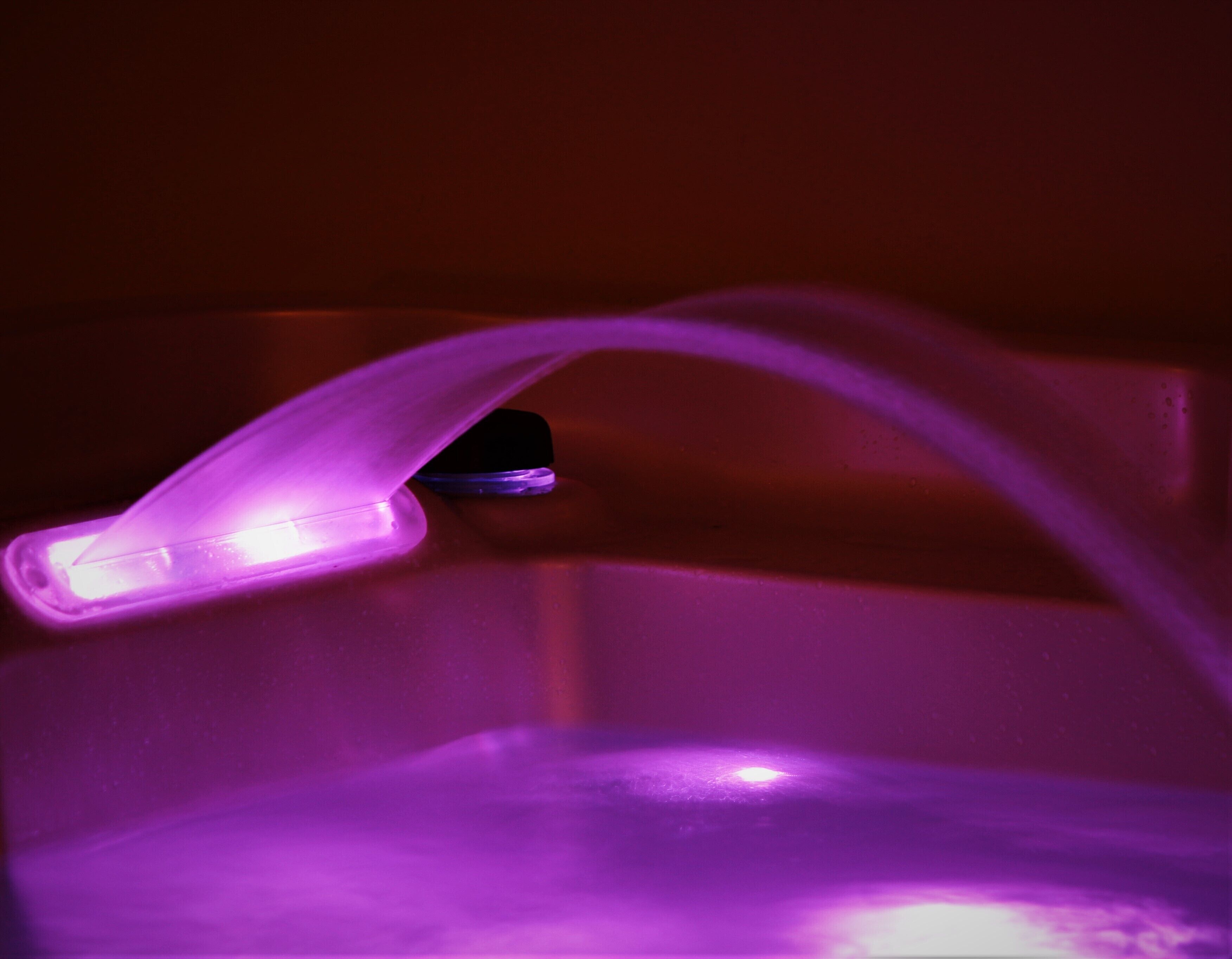 A purple light fixture in a room.