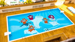 A pool with cartoon characters and a wooden deck.