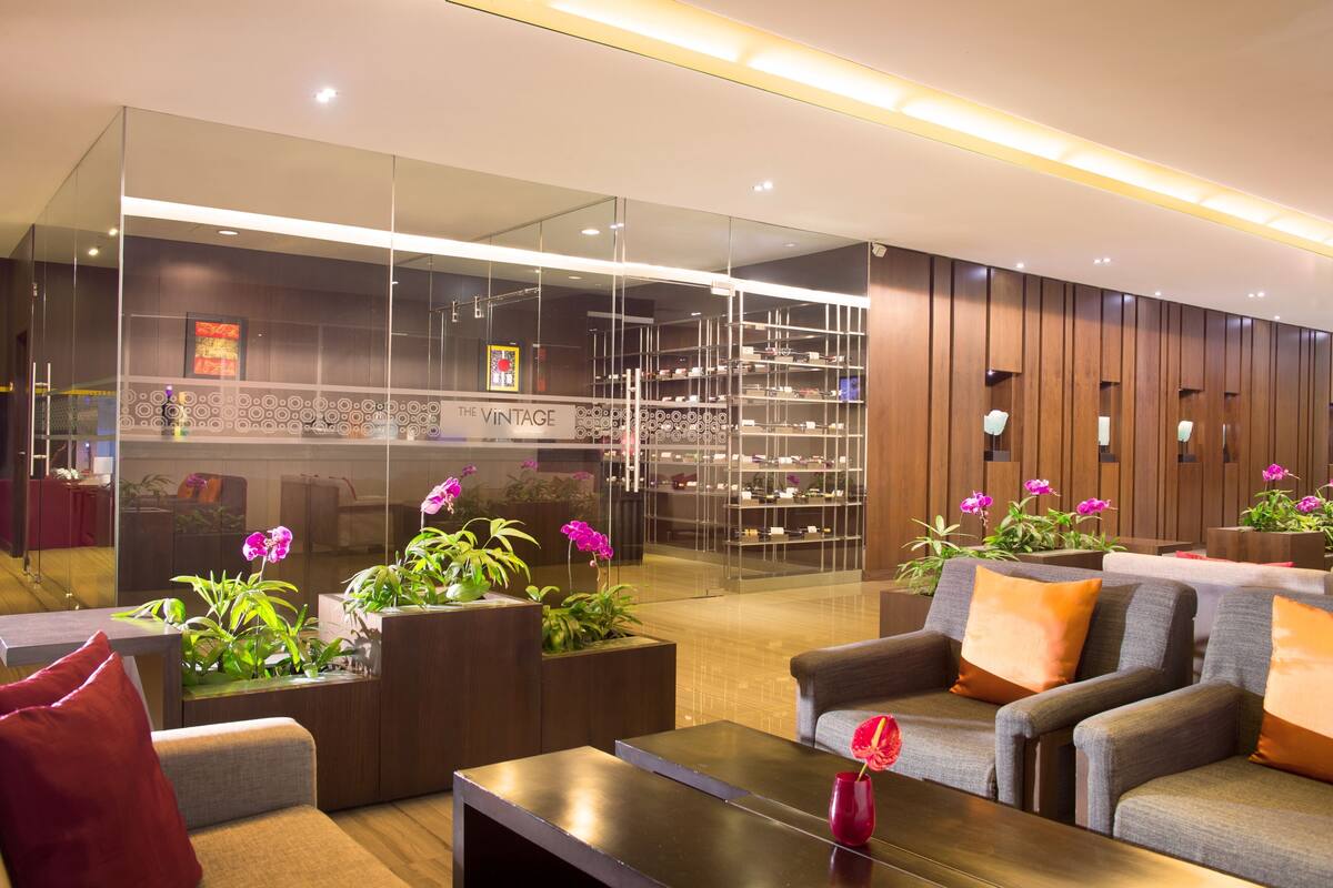 A modern lobby with seating, a reception desk, and a shoe display.