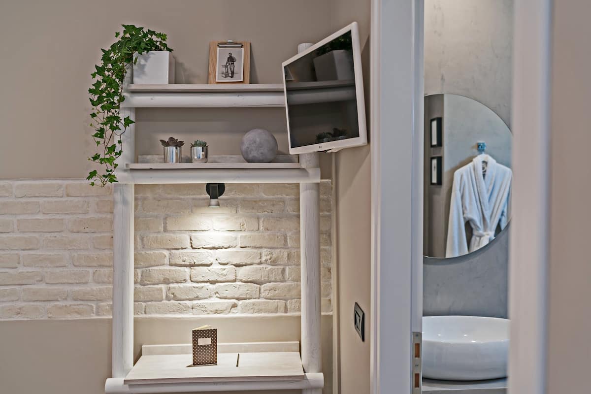 deluxe studio, garden view | in-room safe, desk, blackout curtains, iron/ironing board