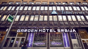 De gevel van Hotel Garden Srbija, modern vormgegeven, met grote ramen en een opvallende ingang.