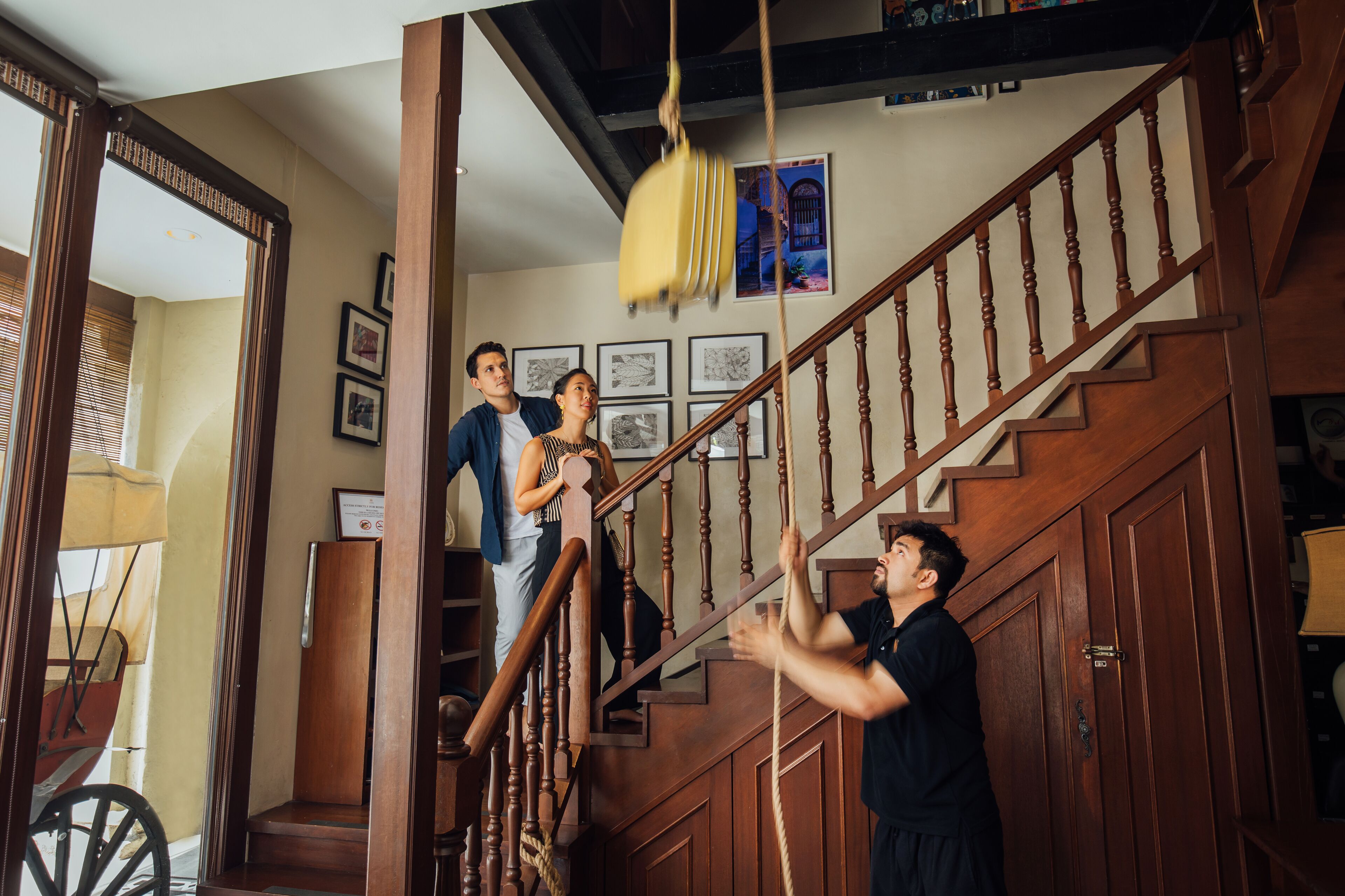 A staircase with wooden railings and a yellow hanging object.