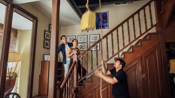 A staircase with wooden railings and a yellow hanging object.
