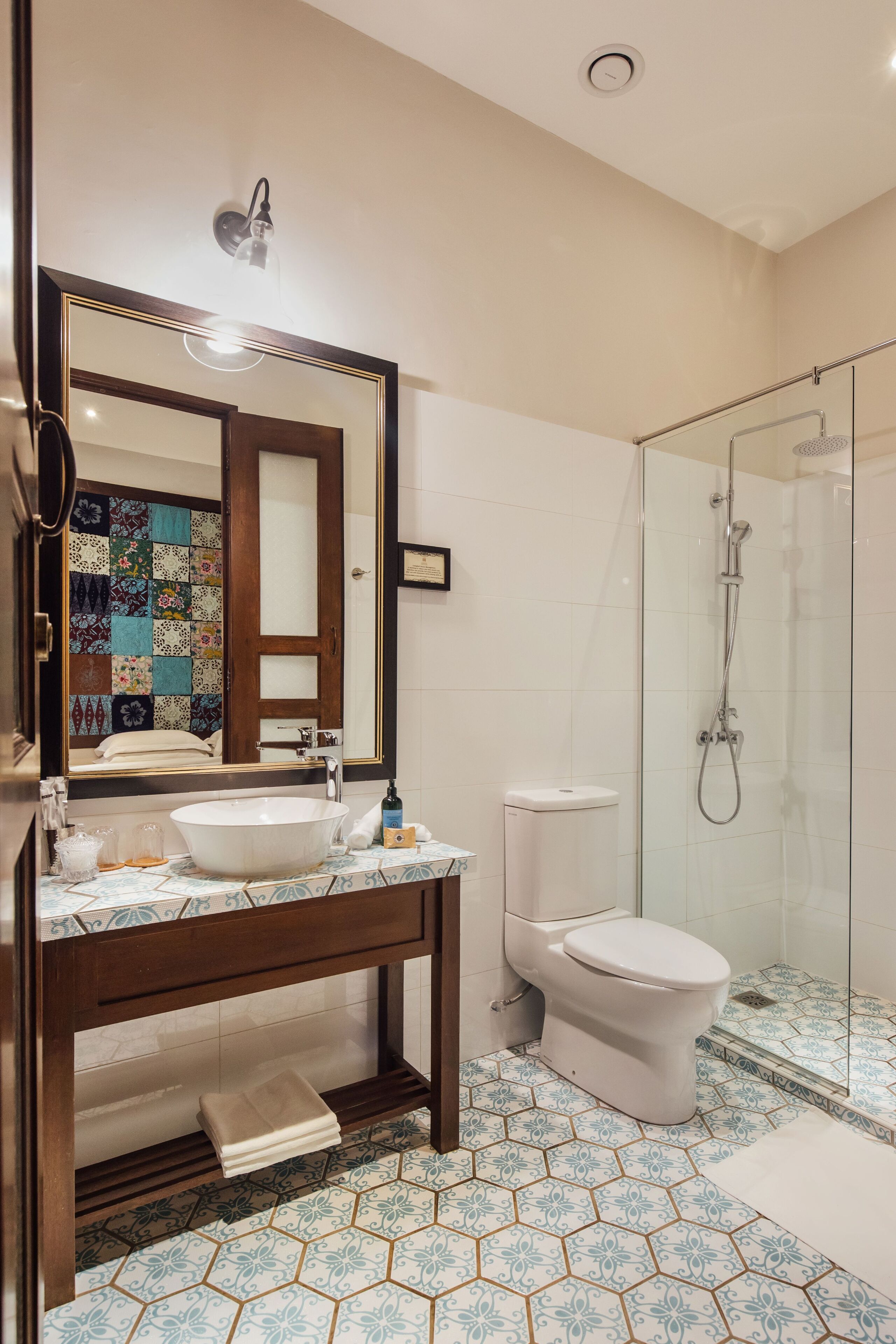 deluxe room | bathroom | shower, rainfall showerhead, designer toiletries, hair dryer