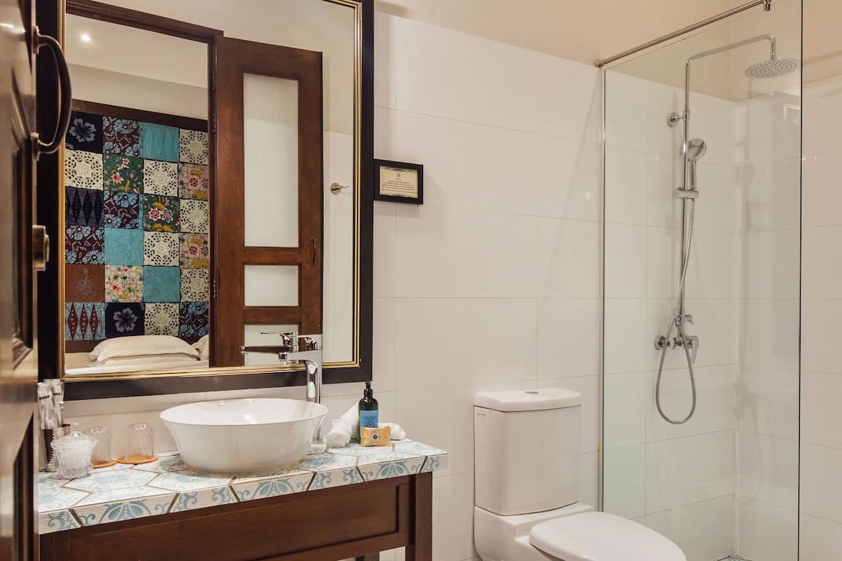deluxe room | bathroom | shower, rainfall showerhead, designer toiletries, hair dryer
