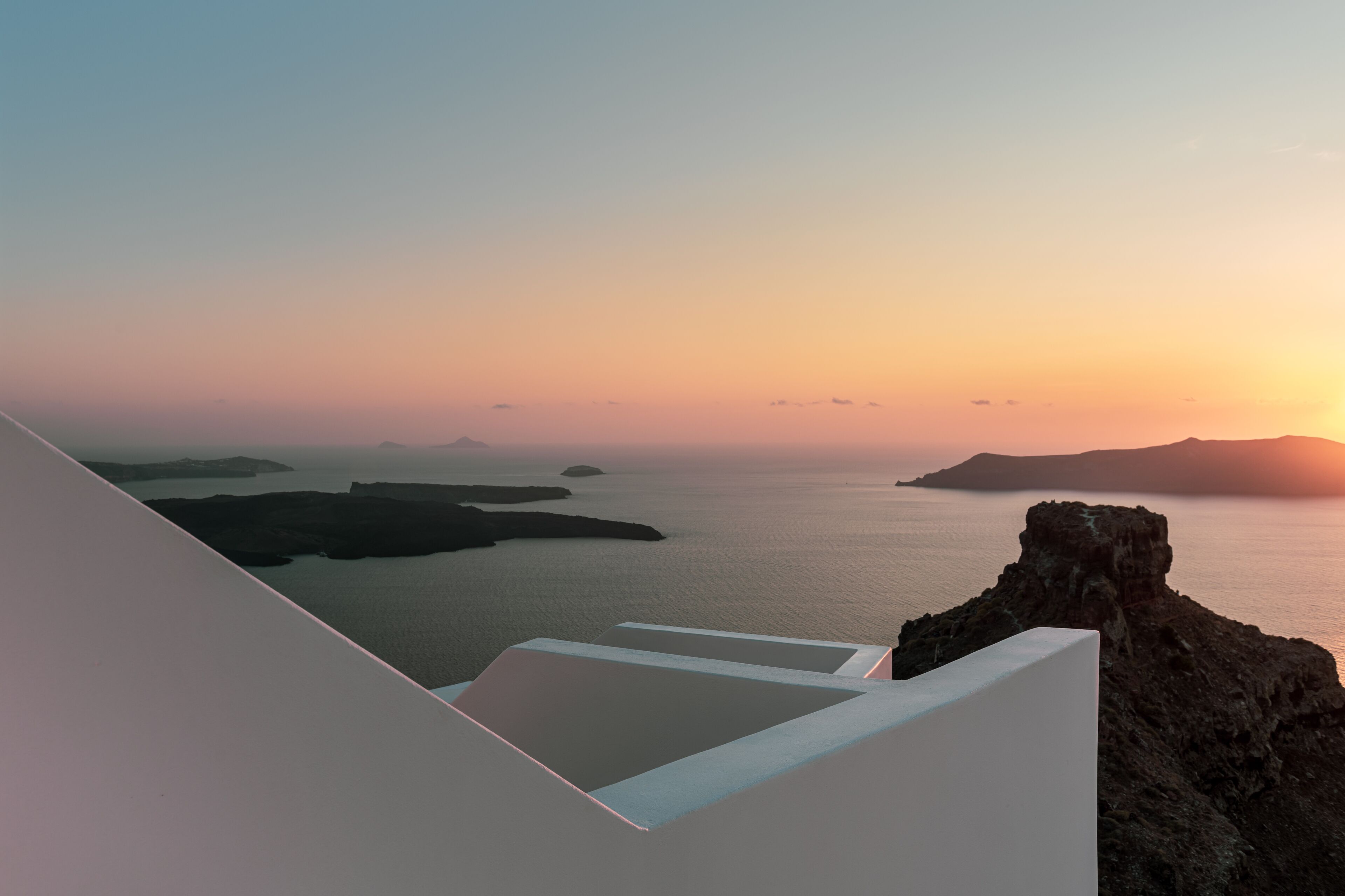 A coastal view with a rocky outcrop and calm sea.