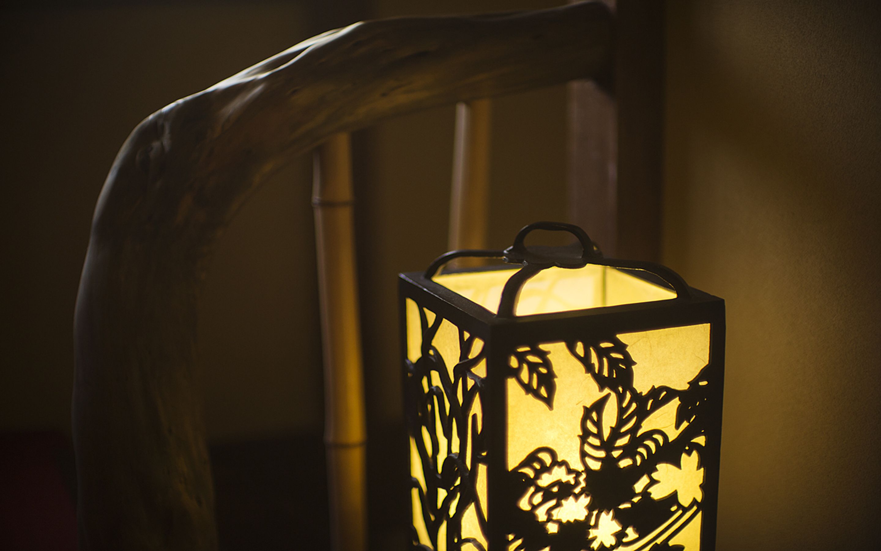 A lantern with a floral design, mounted on a chair.