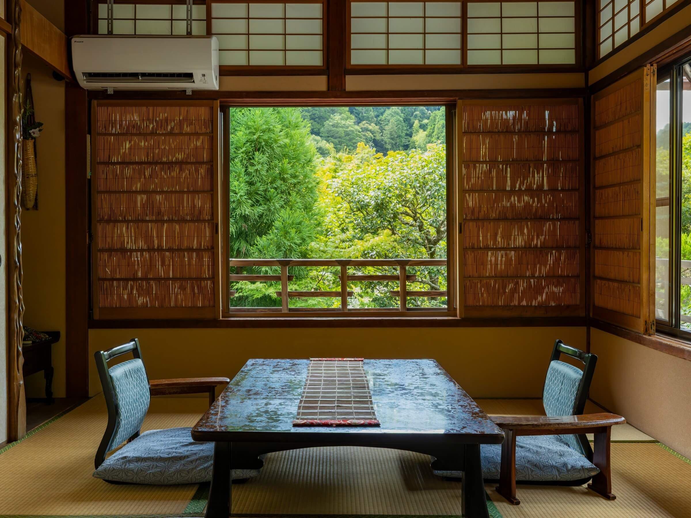 A traditional Japanese room with tatami flooring, a low table, and shoji screens.