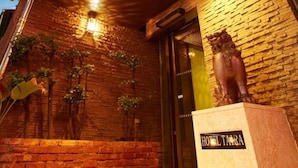 A hotel entrance with a prominent sign reading "HOTEL TARA". - Hotel Taira (Naha)