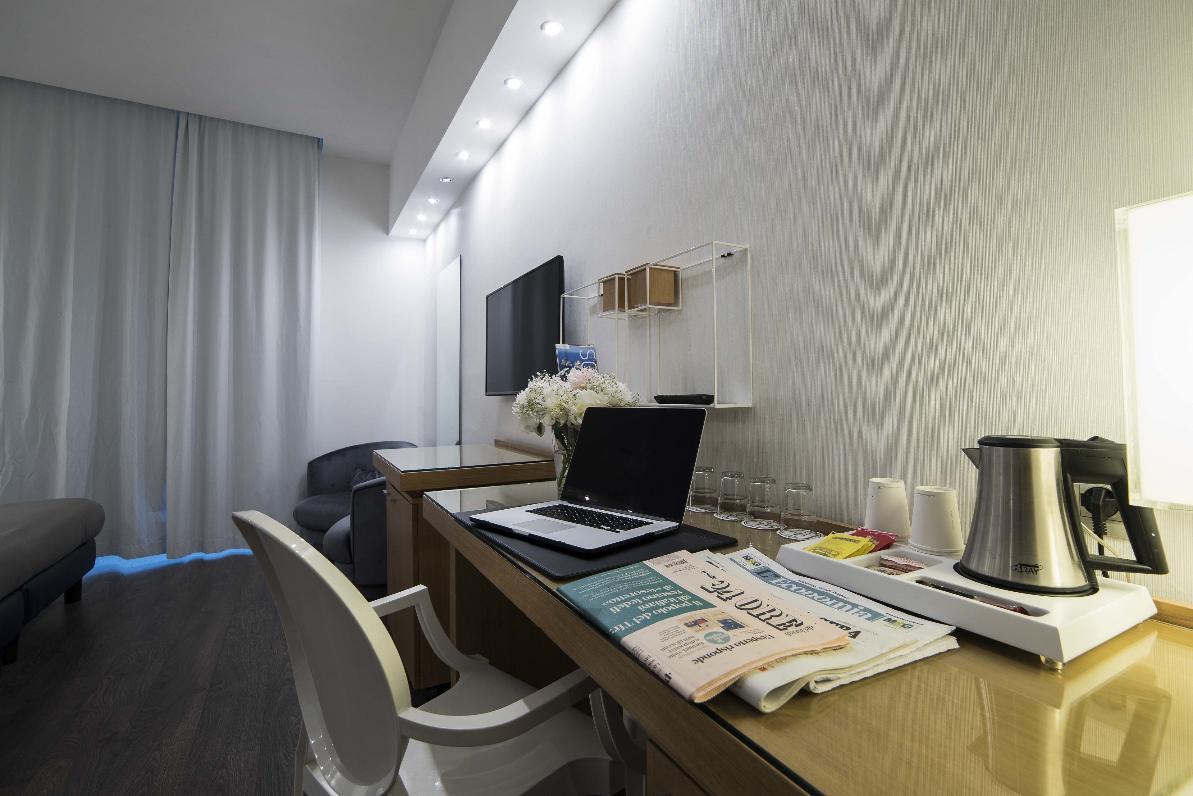 deluxe quadruple room | minibar, in-room safe, desk, blackout curtains