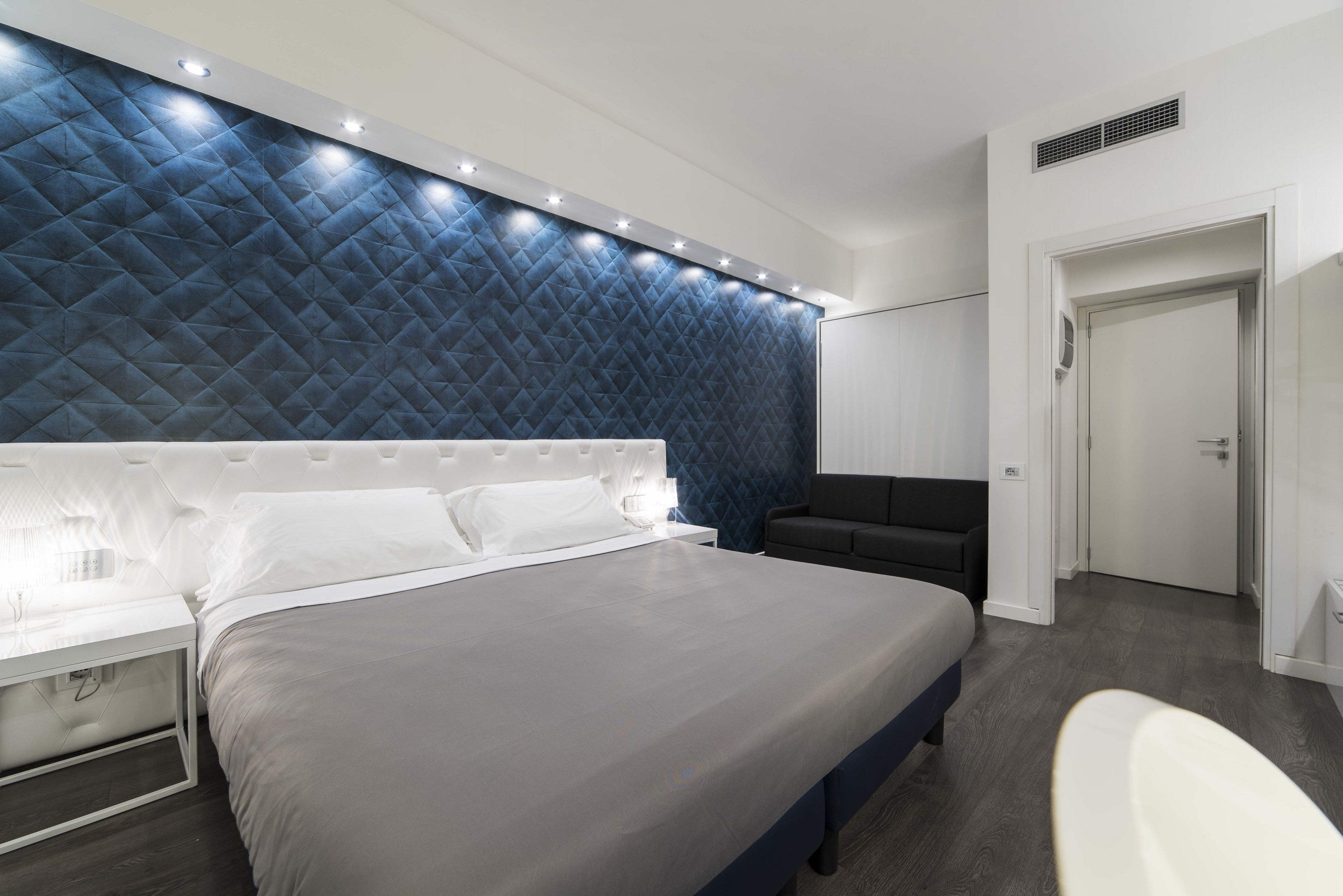 deluxe quadruple room | minibar, in-room safe, desk, blackout curtains