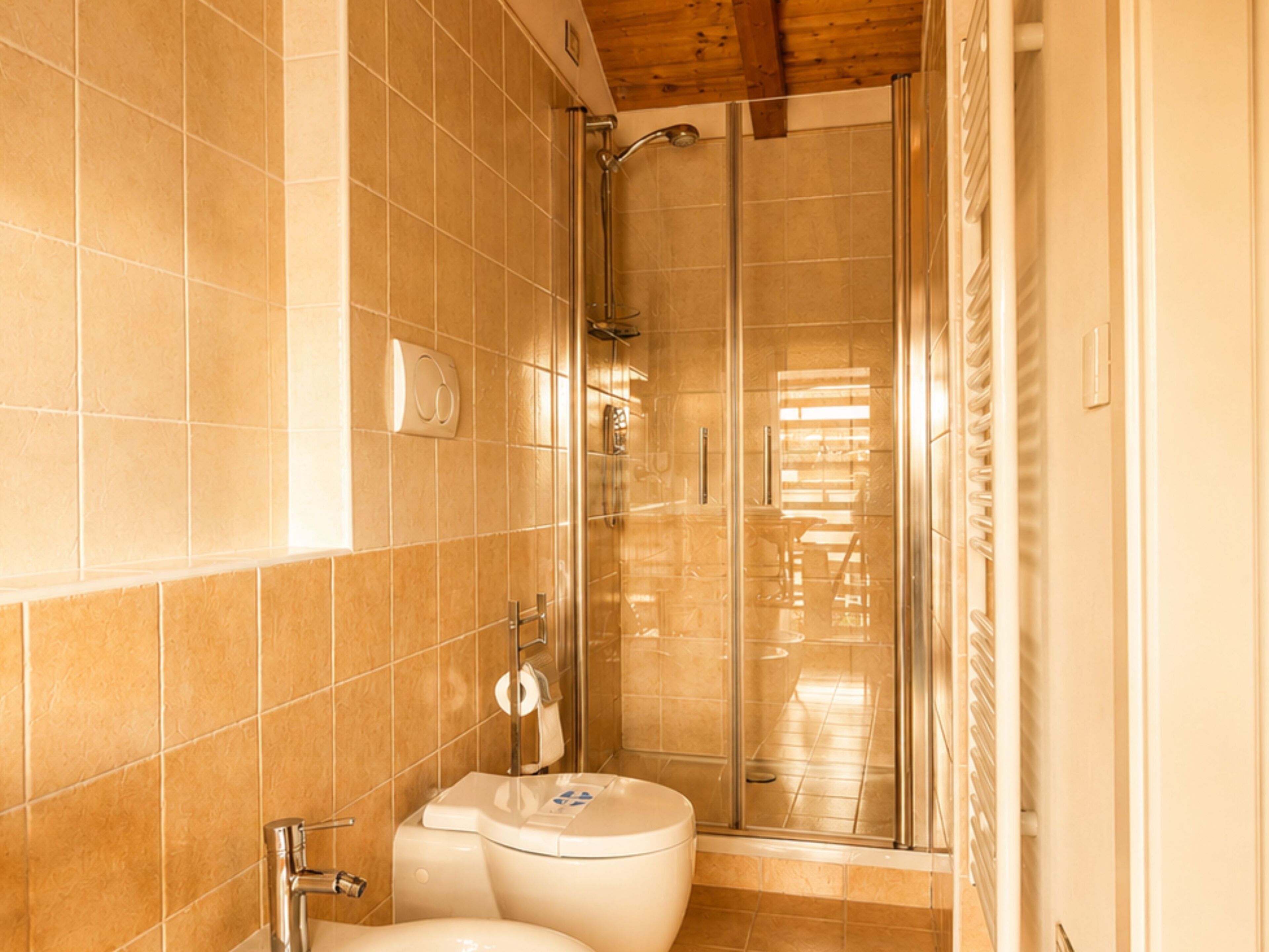 A bathroom with a shower, toilet, and sink.