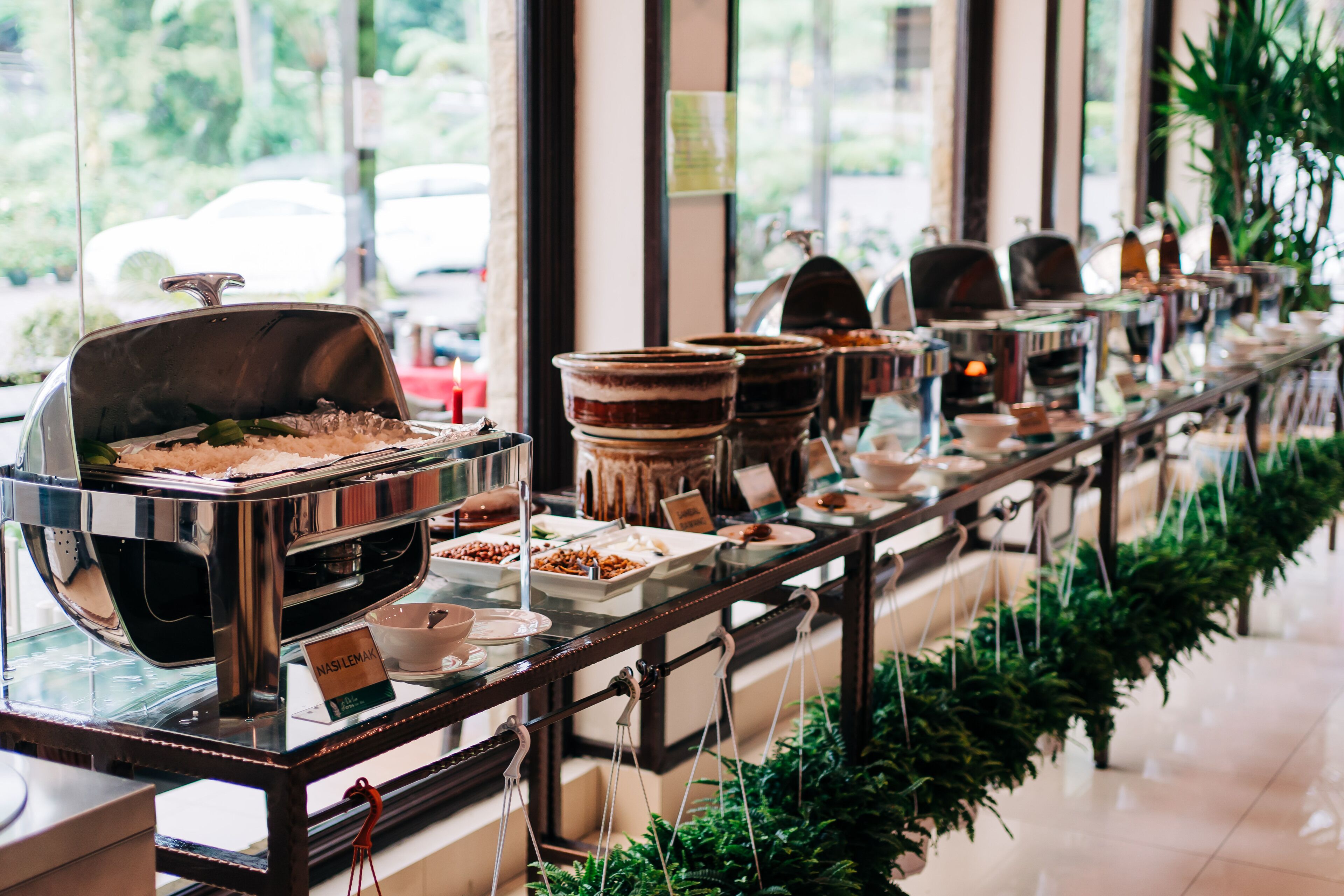 A buffet setup with various food stations and a coffee machine.
