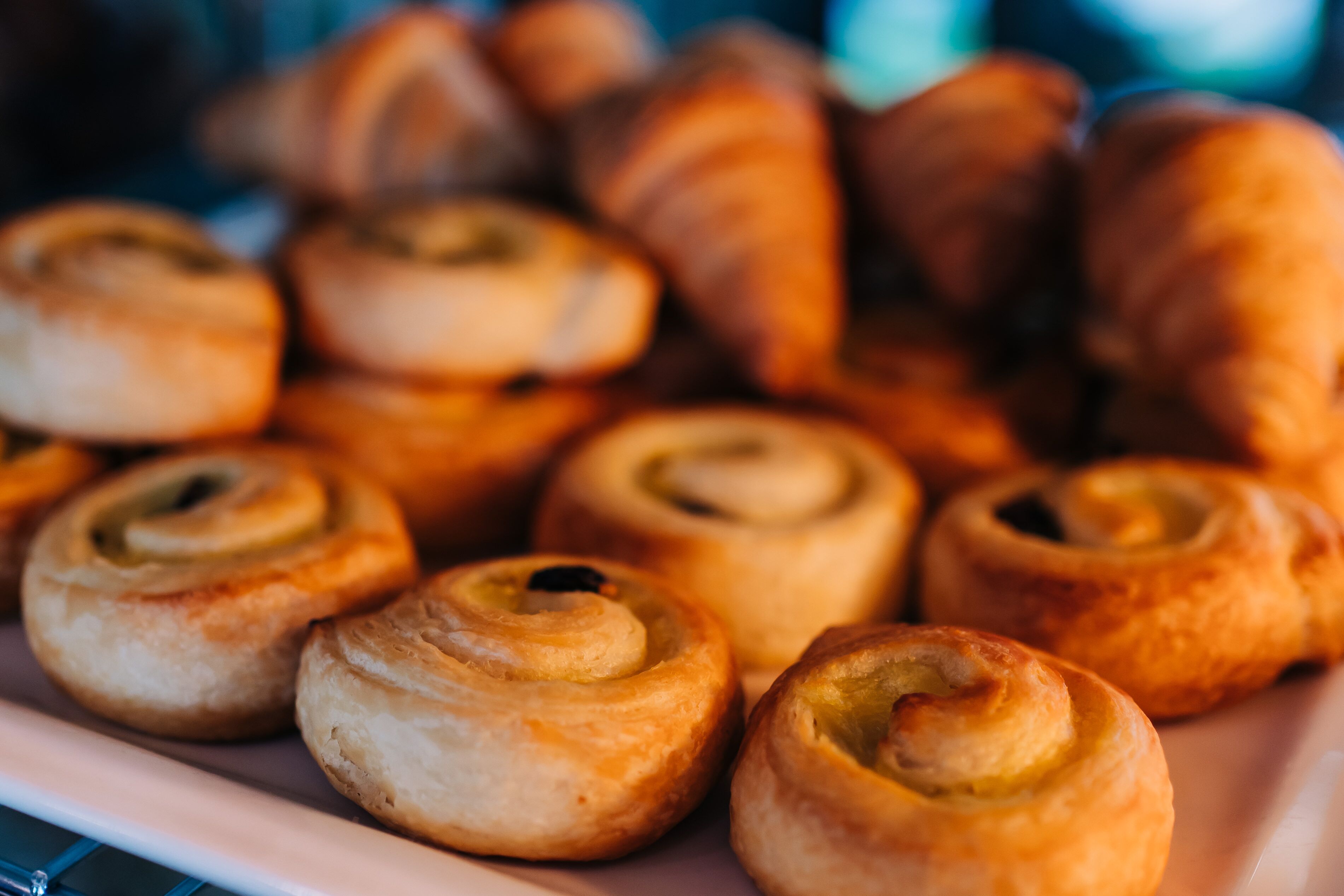 A plate of freshly baked pastries, including croissants and cinnamon rolls.
