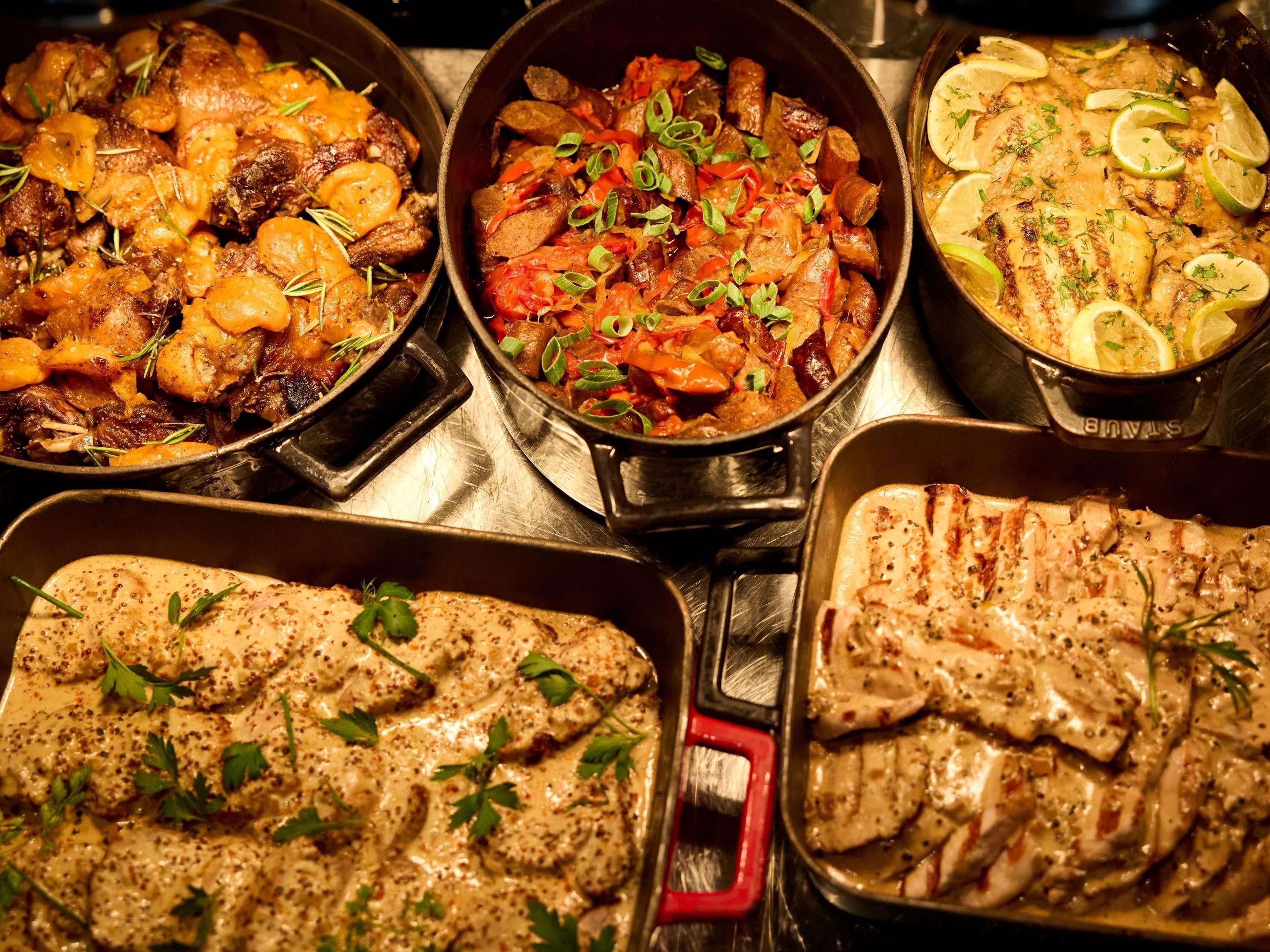 A variety of dishes in cast iron skillets, suggesting a meal setting.
