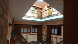 A staircase with a skylight leading to a balcony. - Hermanos Macías Hotel (Ronda)