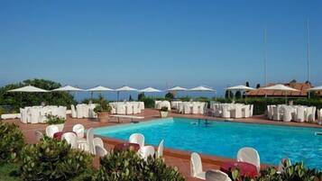 Piscina a l'aire lliure, para-sols i gandules