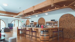 A bar area with wooden beams, a bar counter, stools, and a barrel labeled "RAMON BILBAO." - Hotel Rosatsch - Stammhaus (Pontresina)