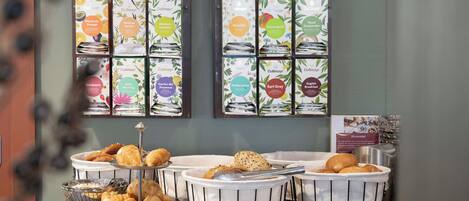 A breakfast buffet with various pastries and coffee options.