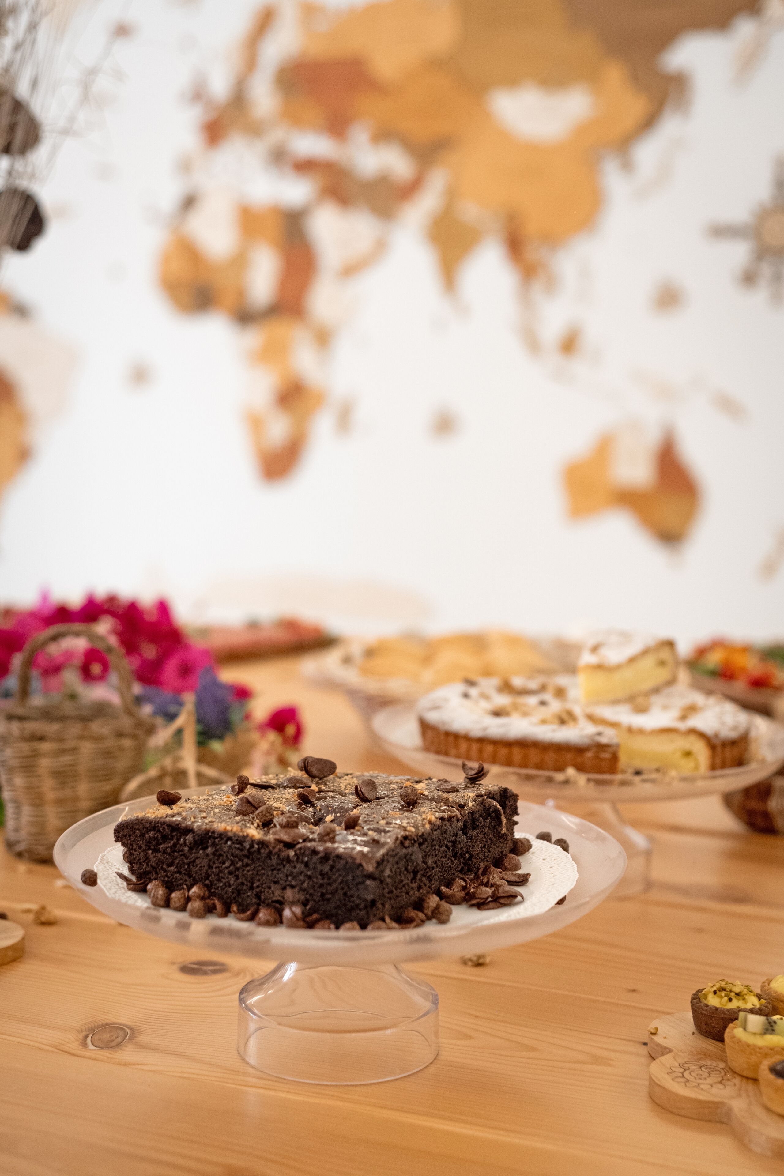 A dessert table with various cakes and pastries, including a chocolate cake with a slice cut out.