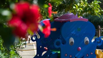 Children can play on this colorful octopus-shaped structure surrounded by lush gardens.