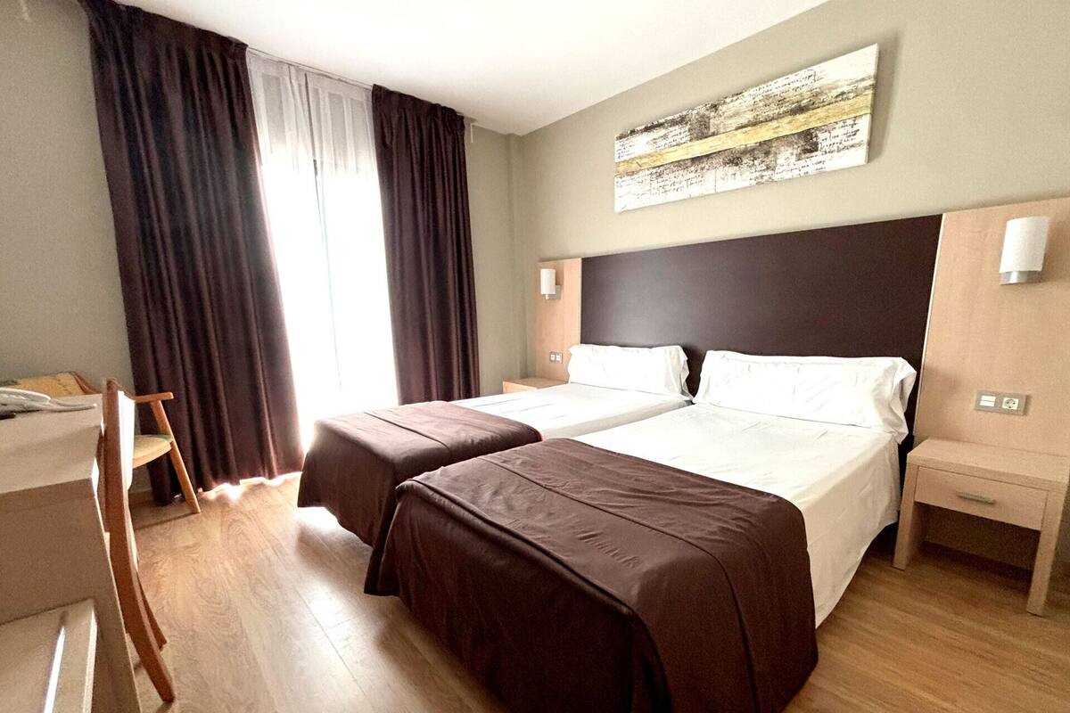Pillowtop beds, desk, blackout drapes, WiFi (free)