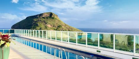 Outdoor pool, open 8:00 AM to 8 PM, pool loungers