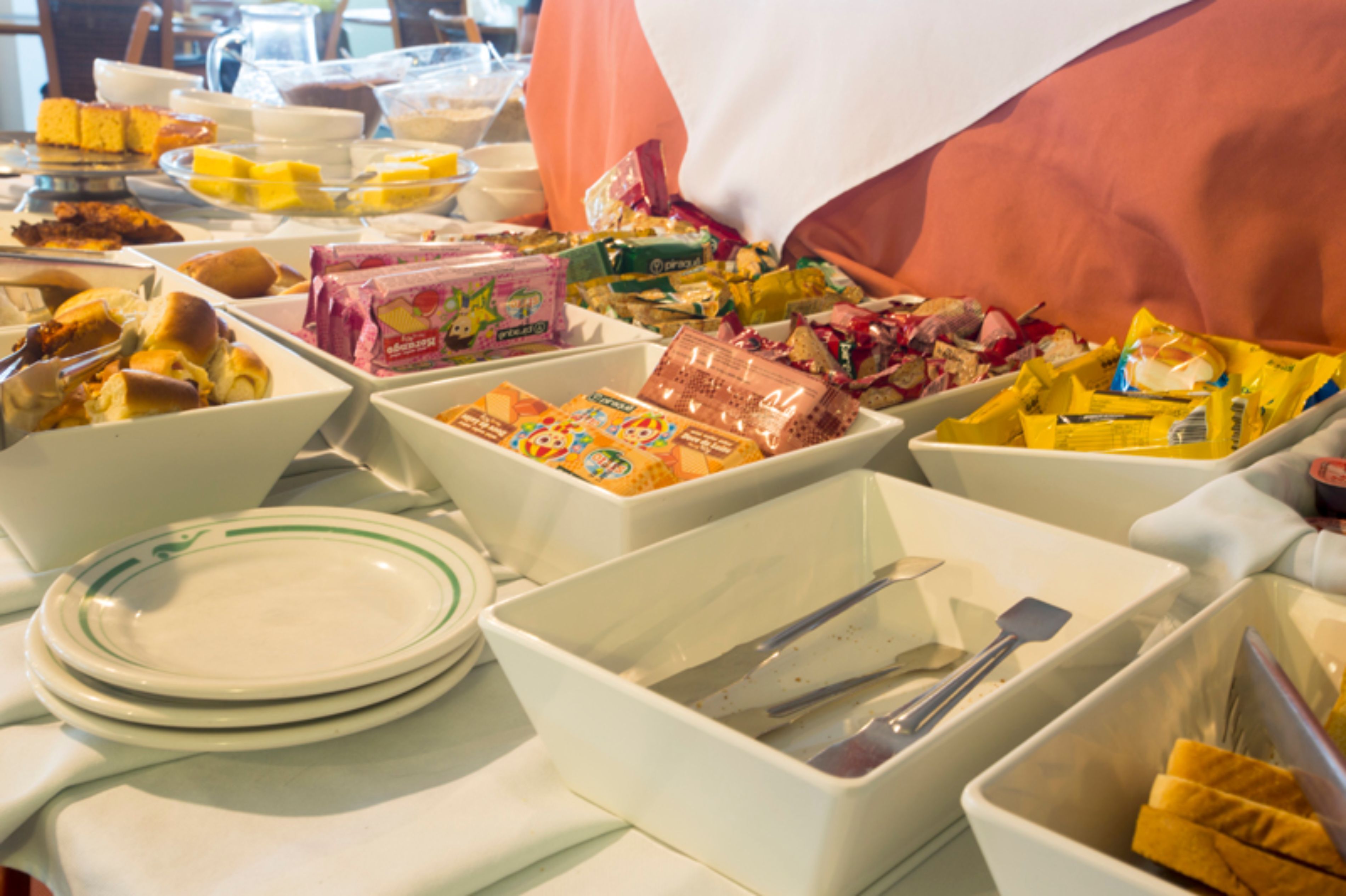 A buffet with various food items and utensils.