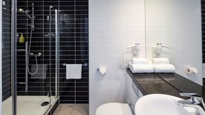 A modern bathroom with a glass-enclosed shower, a white sink, and a toilet. - Holiday Inn Express Amsterdam - South by IHG (Amsterdam)