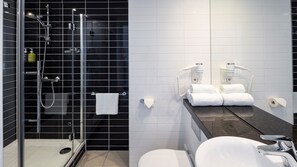 A modern bathroom with a glass-enclosed shower, a white sink, and a toilet. - Holiday Inn Express Amsterdam - South by IHG (Amsterdam)