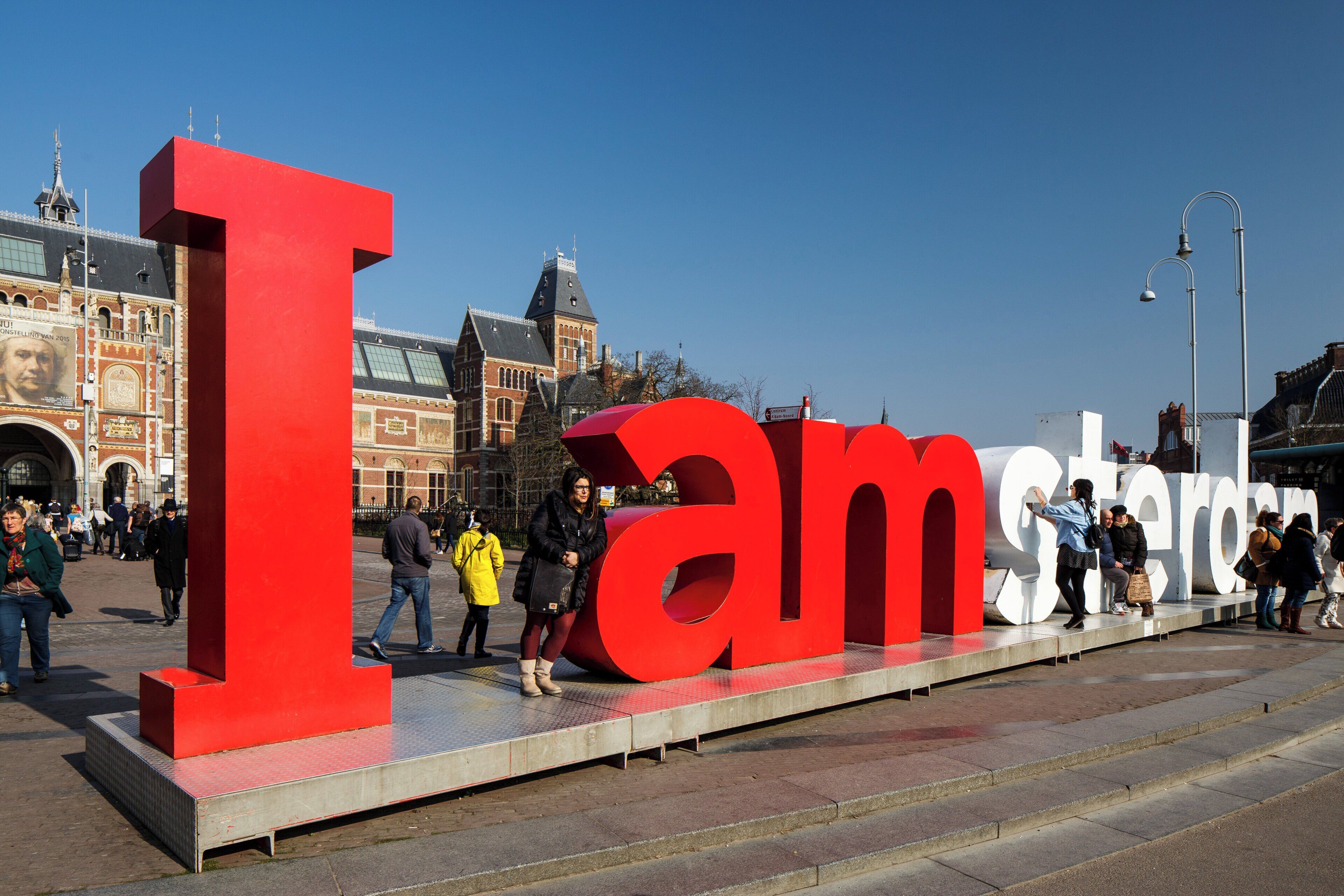 A large outdoor sign with the letters 'I' and 'am' in red, with the word 'Amsterdam' partially visible.