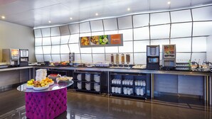 A modern breakfast buffet with a variety of food options and self-service beverage dispensers. - Holiday Inn Express Lisbon - Alfragide by IHG (Oeiras)